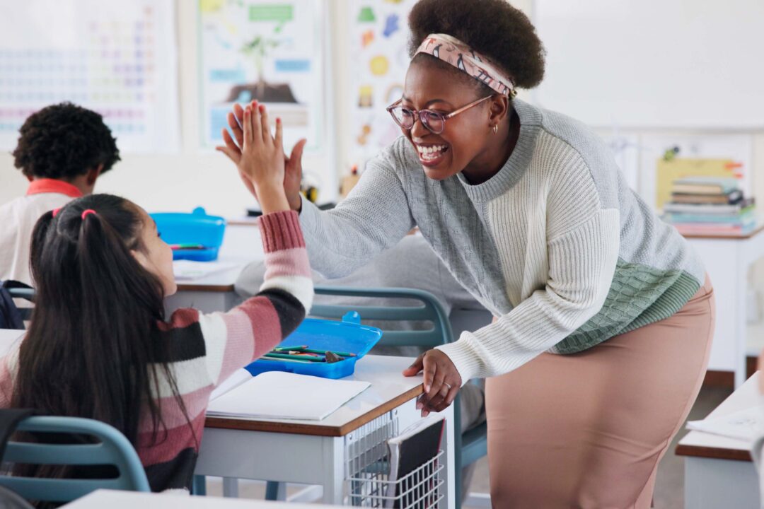 high five with student and teacher